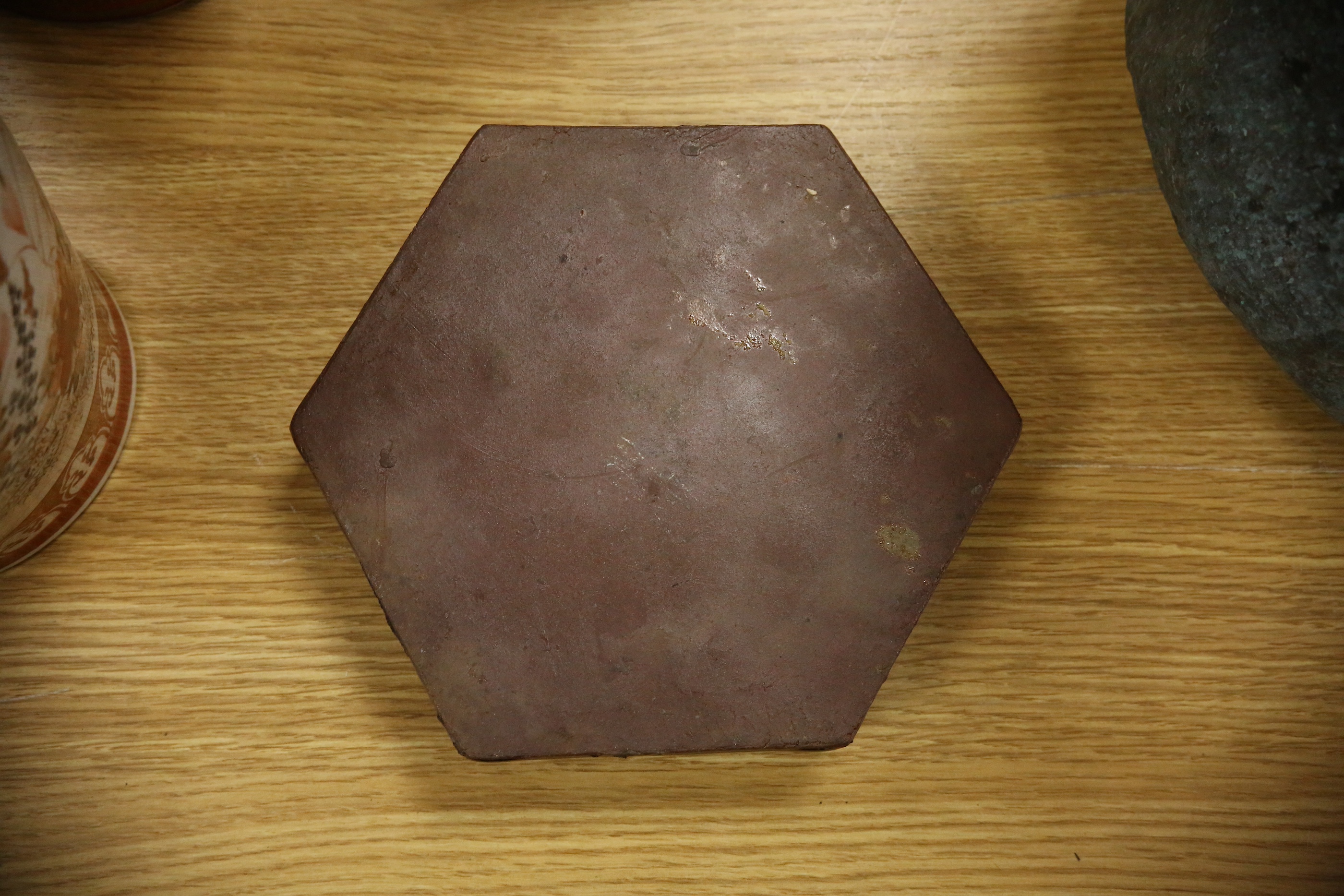 A Japanese studio tenmoku glazed hexagonal box and cover, unmarked, 18cm wide. Condition - good